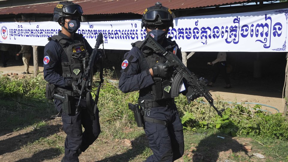 Cambodian police officers guard near brick kilns during a drug destruction ceremony to mark the International Day against Drug Abuse and Illicit Trafficking, outside Phnom Penh, Cambodia, Friday, June 14, 2024. (AP Photo/Heng Sinith)