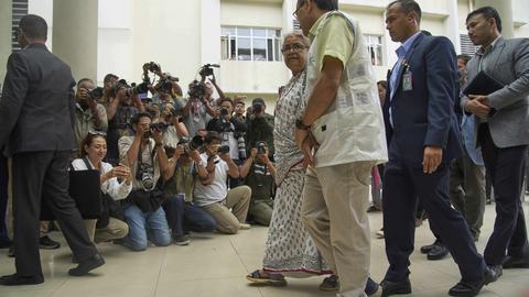 Nepal's interim prime minister Sushila Karki, center, speaks to doctor at Civil hospital as she arrives to meet people injured during anti-corruption protests sparked by a short-lived social media ban in Kathmandu, Nepal, Saturday, Sept. 13, 2025. (AP Photo/Niranjan Shrestha)