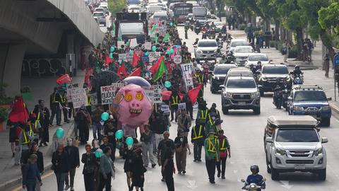 Protesters march to a meeting venue during a demonstration against International Monetary Fund and the World Bank Group in Bangkok, Thailand, Thursday, Oct. 15, 2026. (AP Photo/Sakchai Lalit)