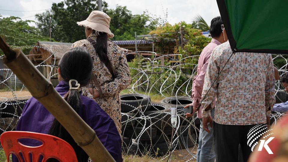 Cambodian civilians stand in front of alleged Thai installed bard wire along the Thai-Cambodian border Thma Puok district, Banteay Meanchey province, August 15, 2025. Kiripost/Mon Sokeo