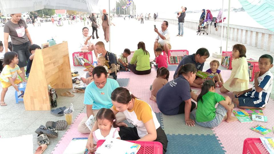 People read books at the Kampot Inclusive Reading Corner (KIRC), a free lending library.