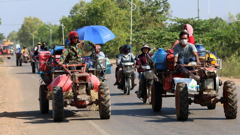 Refugees flee the Cambodia–Thailand border fighting on tractors in Cambodia. Kiripost via AKP