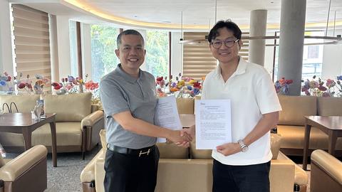 Mr. Phillip, Chairman of Yellow Rabbit Trans (left), and Langda Chea, Founder and CEO of BookMeBus, at the MOU partnership signing event on October 20, 2025.